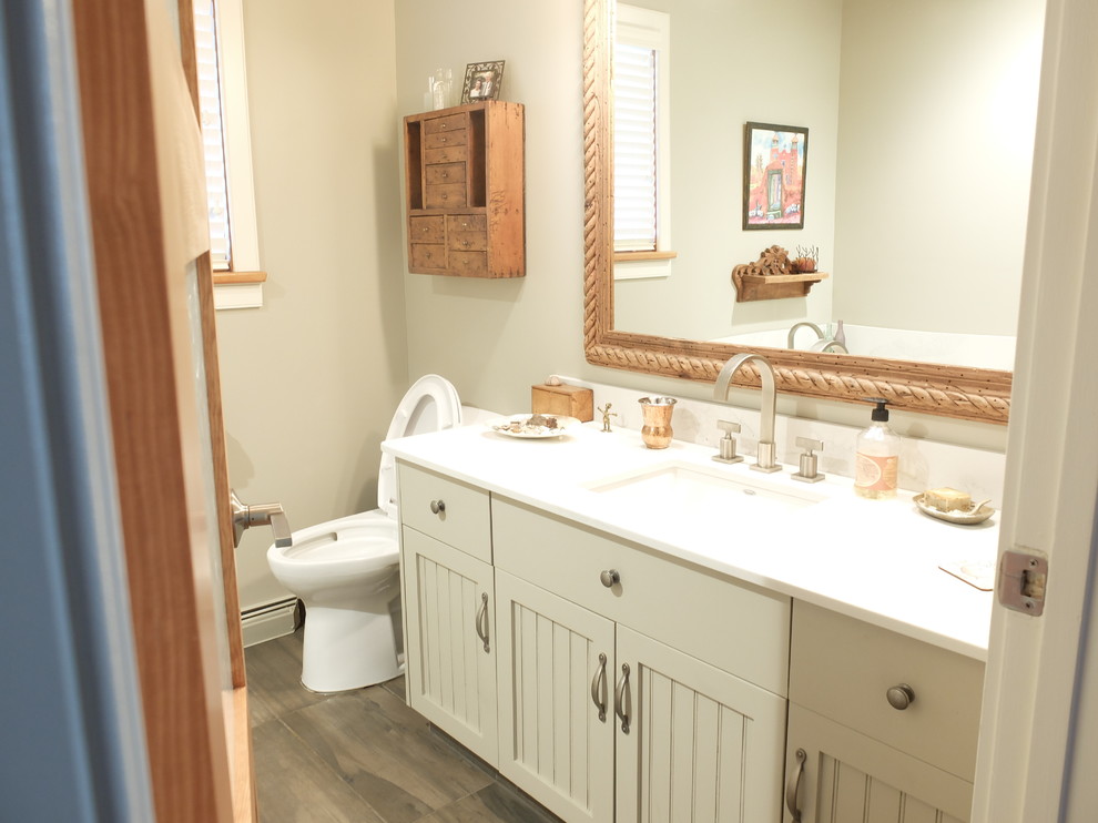 Inspiration for a mid-sized eclectic dark wood floor bathroom remodel in Edmonton with shaker cabinets, white cabinets, a two-piece toilet, white walls and an undermount sink