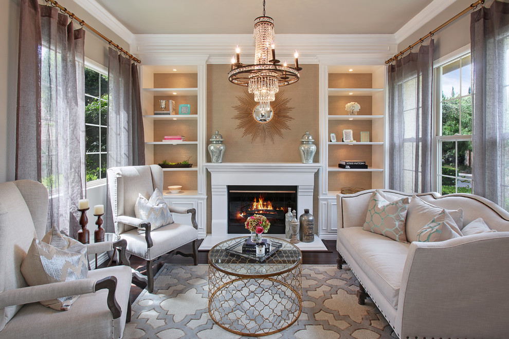 Inspiration for a transitional living room in Orange County with beige walls, dark hardwood floors and a standard fireplace.