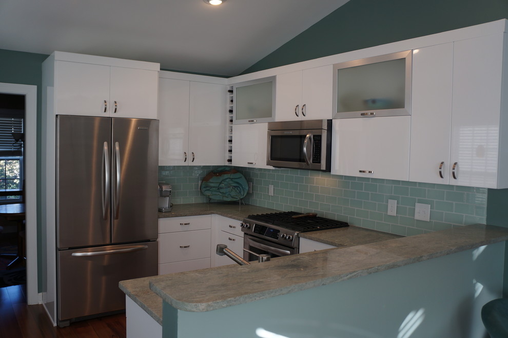 Photo of a small modern u-shaped eat-in kitchen in Raleigh with an undermount sink, flat-panel cabinets, white cabinets, marble benchtops, green splashback, glass tile splashback, stainless steel appliances, medium hardwood floors and no island.