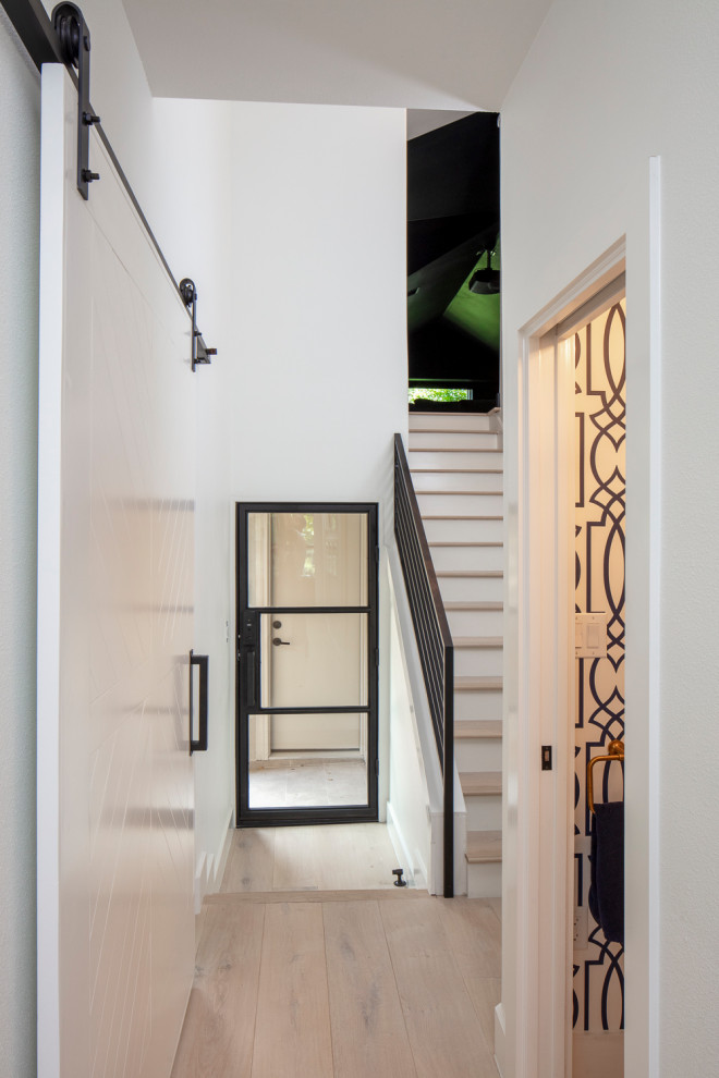 Mid-sized transitional light wood floor and beige floor hallway photo in Austin with white walls