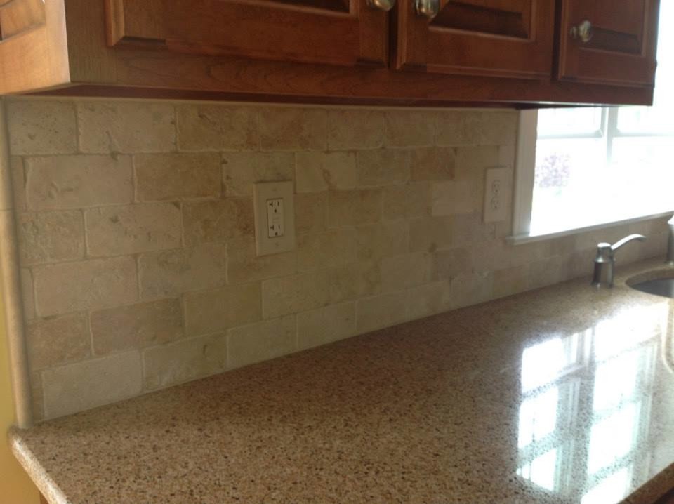 Inspiration for a single-wall open concept kitchen remodel with raised-panel cabinets, medium tone wood cabinets, granite countertops, beige backsplash, ceramic backsplash and stainless steel appliances