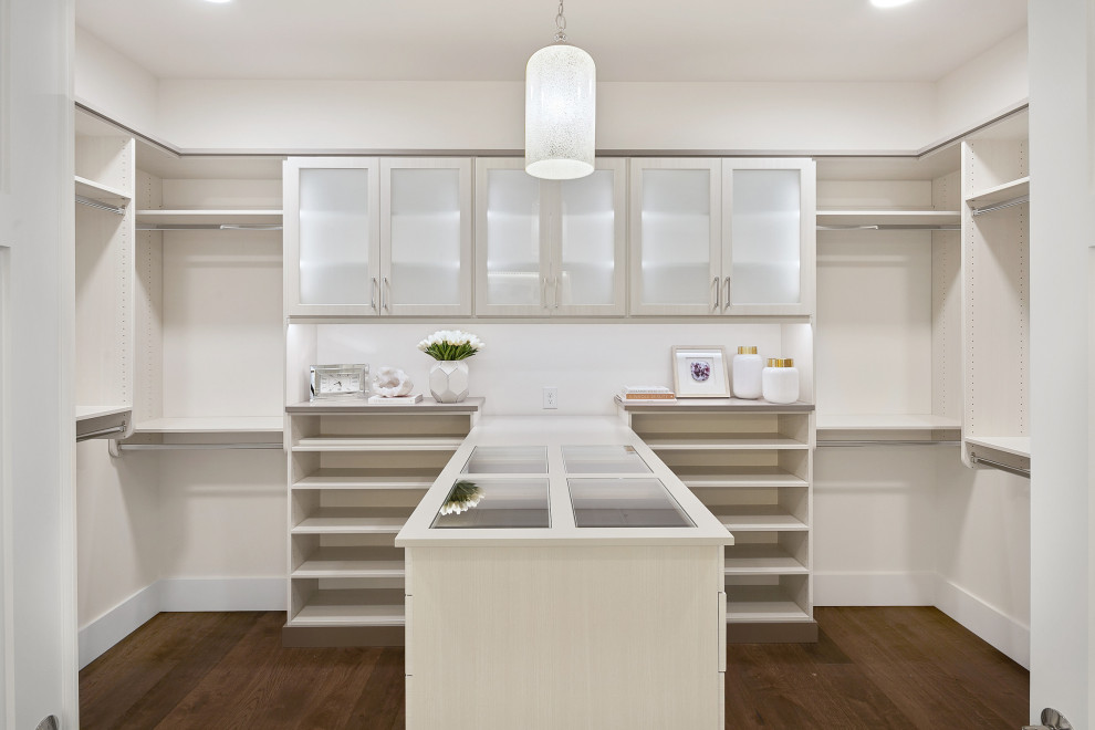 This is an example of a large arts and crafts gender-neutral walk-in wardrobe in Seattle with glass-front cabinets, light wood cabinets, medium hardwood floors and brown floor.