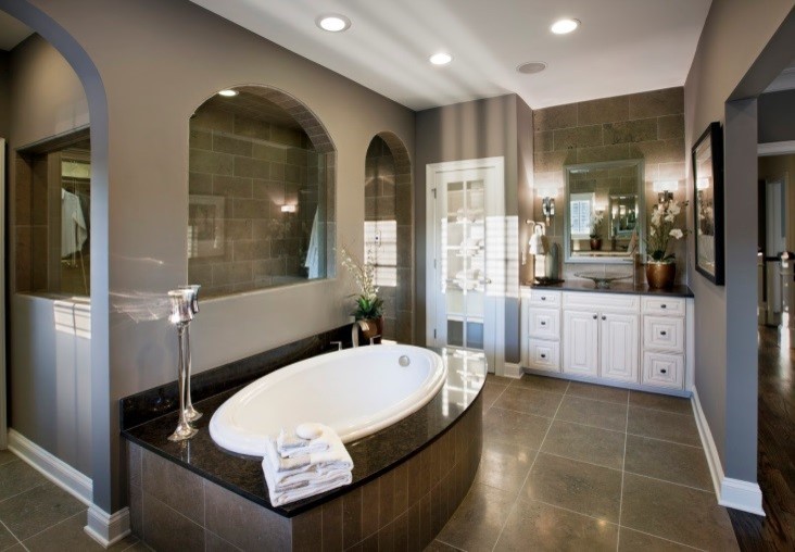 Inspiration for a large traditional master bathroom in Raleigh with a vessel sink, raised-panel cabinets, white cabinets, granite benchtops, a drop-in tub, an open shower, gray tile, ceramic tile, grey walls and ceramic floors.
