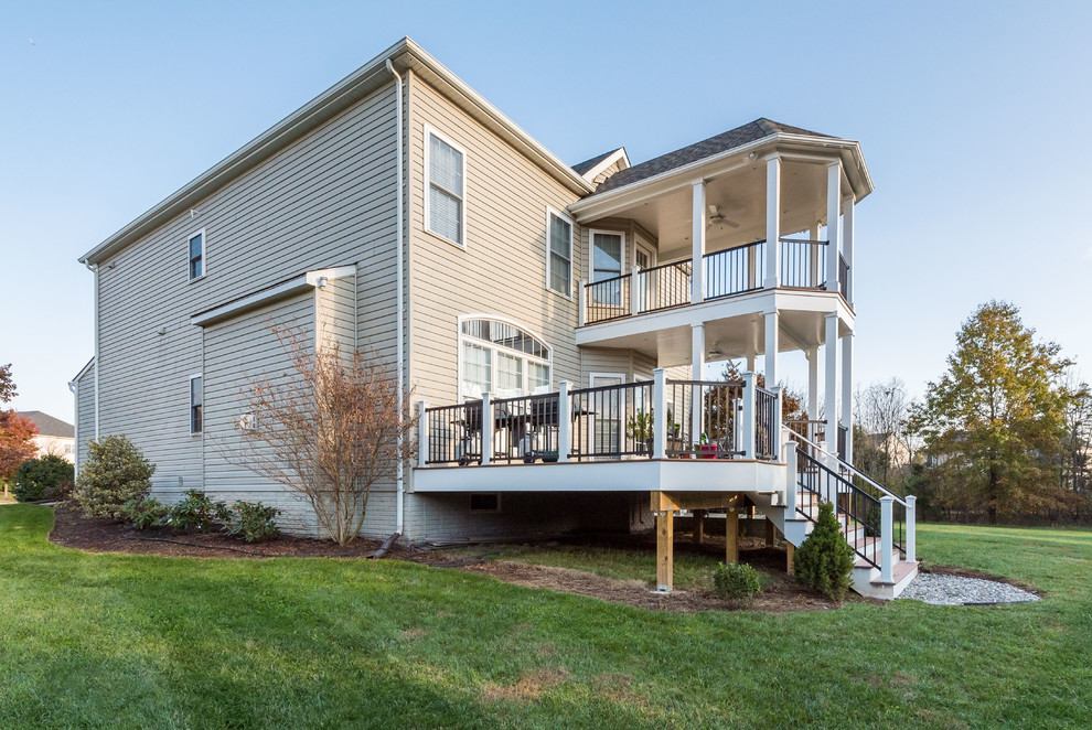 Deck - large transitional backyard deck idea with a roof extension and decking