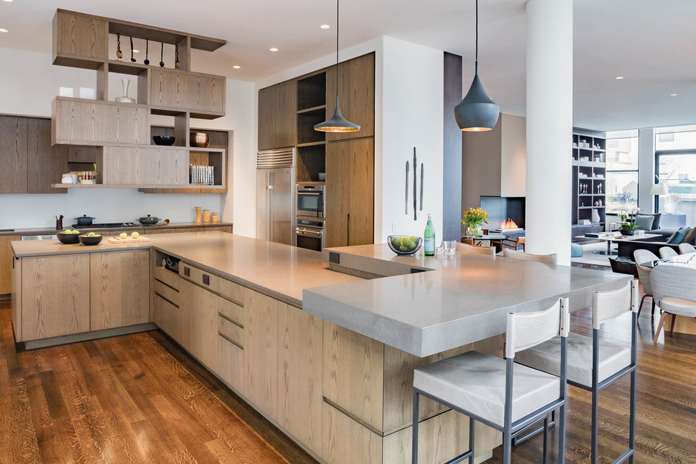 Inspiration for a large contemporary kitchen in New York with a double-bowl sink, flat-panel cabinets, medium wood cabinets, quartz benchtops, white splashback, glass sheet splashback, stainless steel appliances, medium hardwood floors, with island, brown floor and beige benchtop.