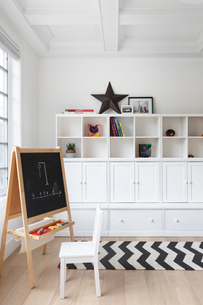 Transitional gender-neutral kids' playroom in Calgary with white walls, light hardwood floors, beige floor and coffered for kids 4-10 years old.