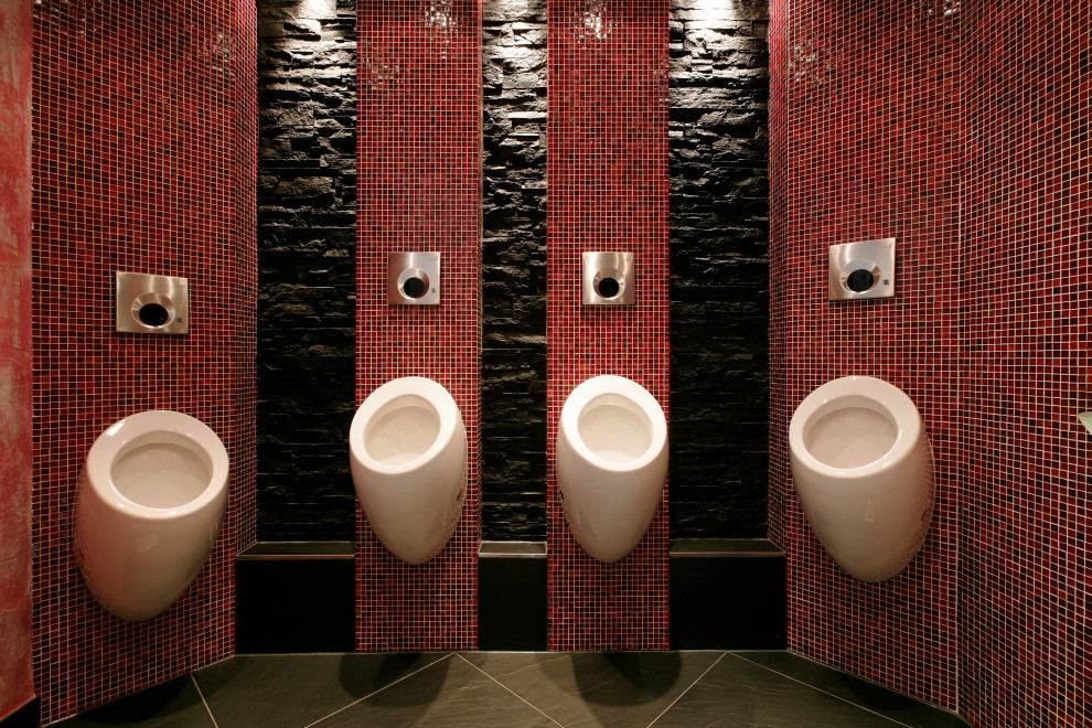 Expansive world-inspired cloakroom in Munich with a wall mounted toilet, red tiles, glass tiles, black walls, slate flooring, a console sink, glass worktops, black floors, feature lighting, a freestanding vanity unit and a drop ceiling.