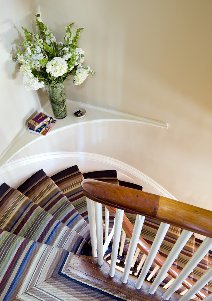 This is an example of an eclectic carpeted curved staircase in Boston.