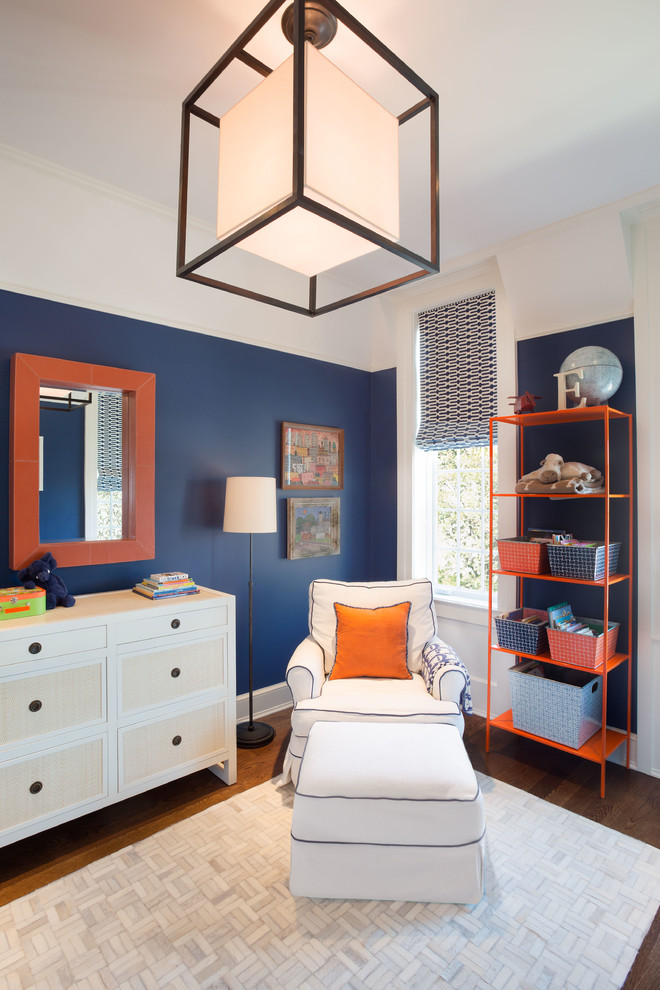 Large transitional nursery in Chicago with blue walls and dark hardwood floors for boys.