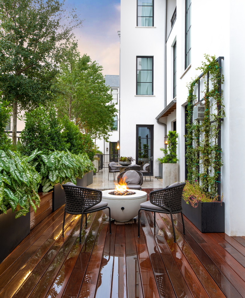 Inspiration for a transitional backyard patio in Dallas with a fire feature, decking and no cover.