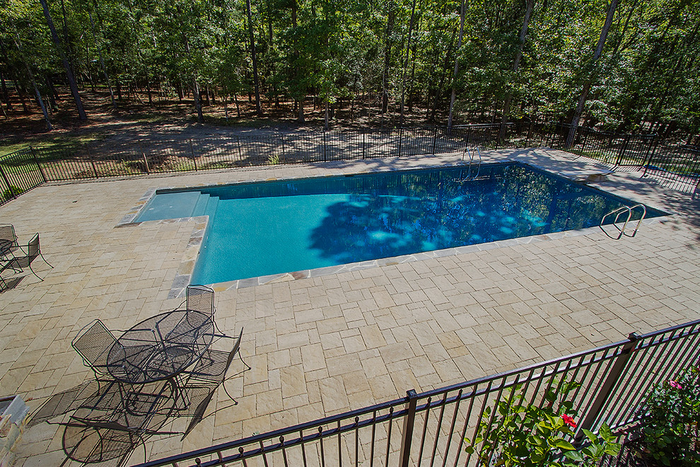 Inspiration for a huge rustic backyard concrete paver and rectangular lap pool remodel in Raleigh