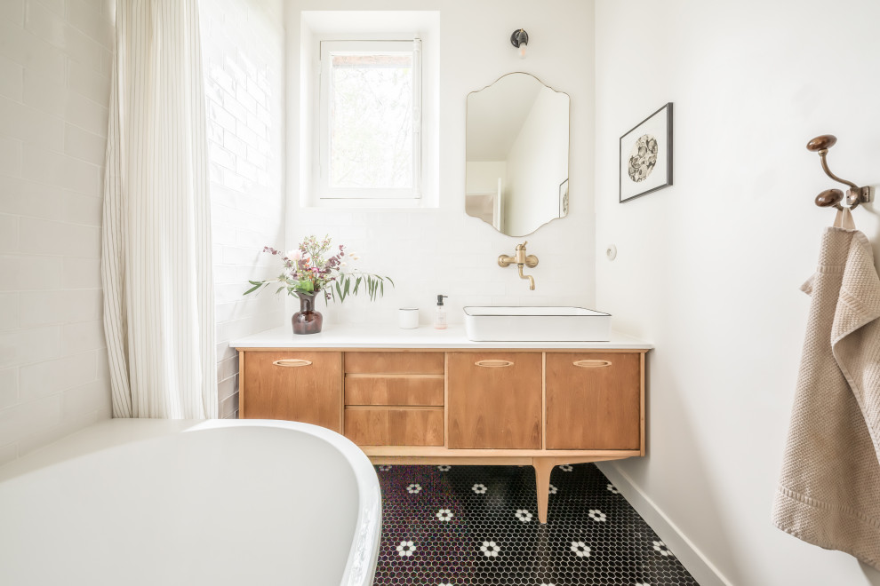 Idée de décoration pour une salle de bain design en bois brun avec un placard à porte plane, un carrelage blanc, un mur blanc, un sol en carrelage de terre cuite, une vasque, un sol noir, un plan de toilette blanc, meuble simple vasque et meuble-lavabo sur pied.