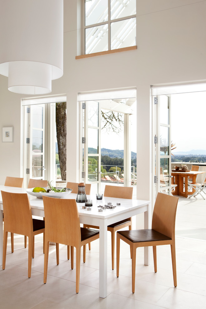 This is an example of a contemporary dining room in San Francisco with white walls.