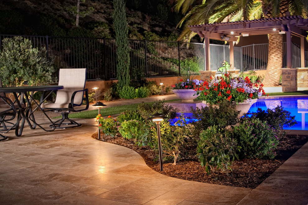 Large backyard garden in San Diego with concrete pavers.