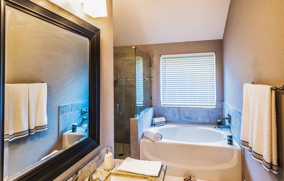 Inspiration for a mid-sized transitional master beige tile and ceramic tile ceramic tile and beige floor drop-in bathtub remodel in Phoenix with raised-panel cabinets, white cabinets, beige walls, an undermount sink, granite countertops and a hinged shower door
