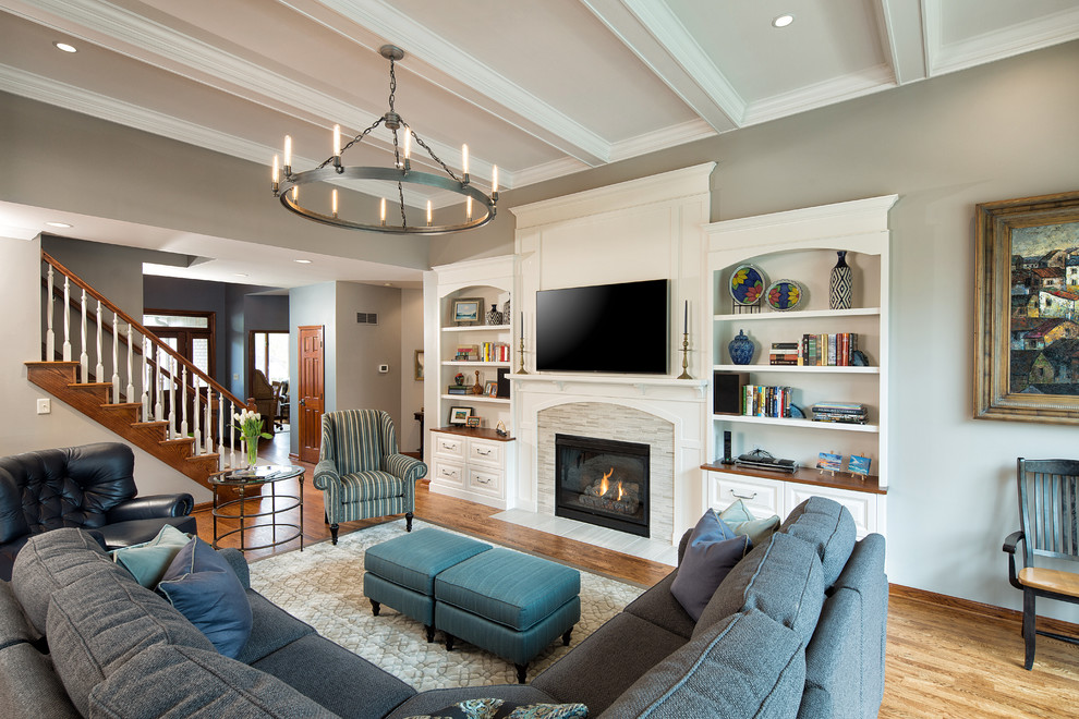 This is an example of a large transitional living room in Other with grey walls, medium hardwood floors, a standard fireplace, a built-in media wall and a tile fireplace surround.