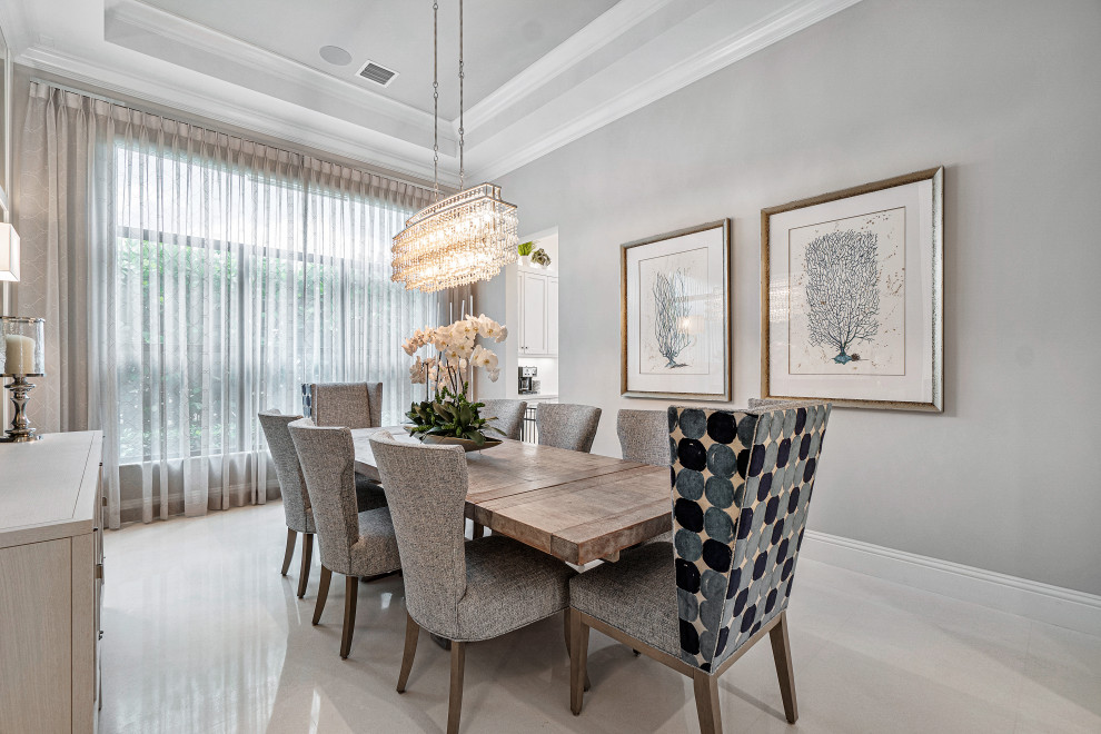 Large classic open plan dining room in Miami with blue walls, marble flooring, beige floors and a coffered ceiling.
