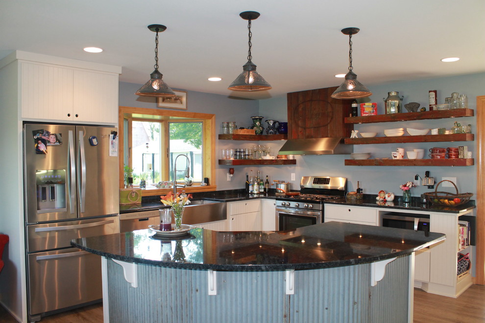 Photo of a mid-sized country l-shaped eat-in kitchen in Minneapolis with a farmhouse sink, flat-panel cabinets, white cabinets, granite benchtops, stainless steel appliances and with island.