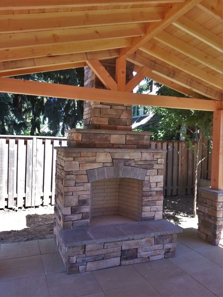 Photo of a mid-sized backyard patio in Portland with a fire feature, concrete slab and a gazebo/cabana.