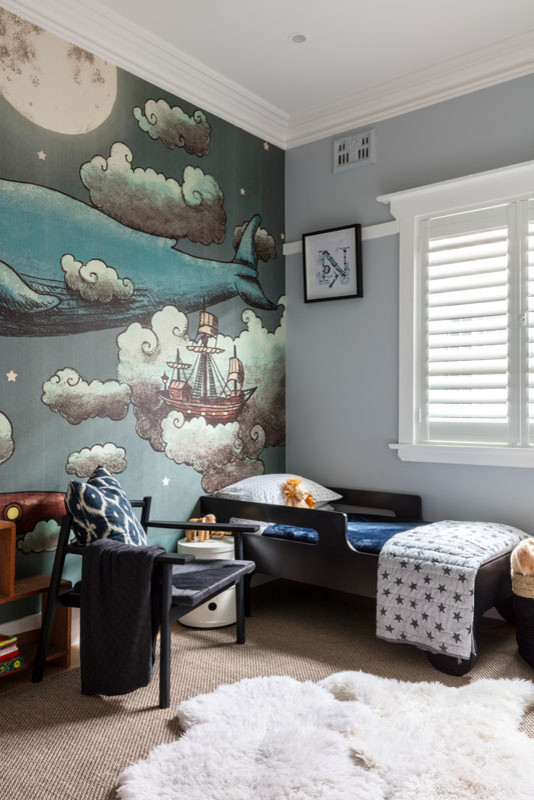 Small beach style nursery in Sydney with blue walls and carpet for boys.