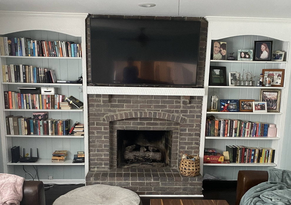 カンザスシティにあるお手頃価格の小さなトラディショナルスタイルのおしゃれなオープンリビング (白い壁、標準型暖炉、レンガの暖炉まわり、壁掛け型テレビ、茶色い床) の写真