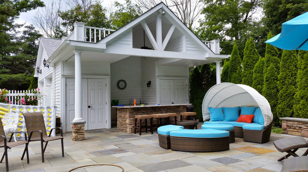 Photo of a large traditional backyard patio in New York with an outdoor kitchen, tile and a gazebo/cabana.