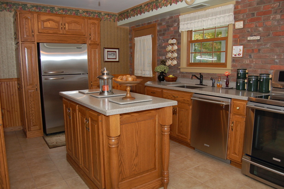 Inspiration for a mid-sized transitional l-shaped light wood floor enclosed kitchen remodel with a double-bowl sink, light wood cabinets, granite countertops, beige backsplash, ceramic backsplash, stainless steel appliances, an island and raised-panel cabinets