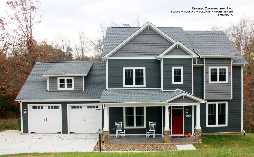 This is an example of a mid-sized traditional two-storey grey exterior in Other with concrete fiberboard siding.