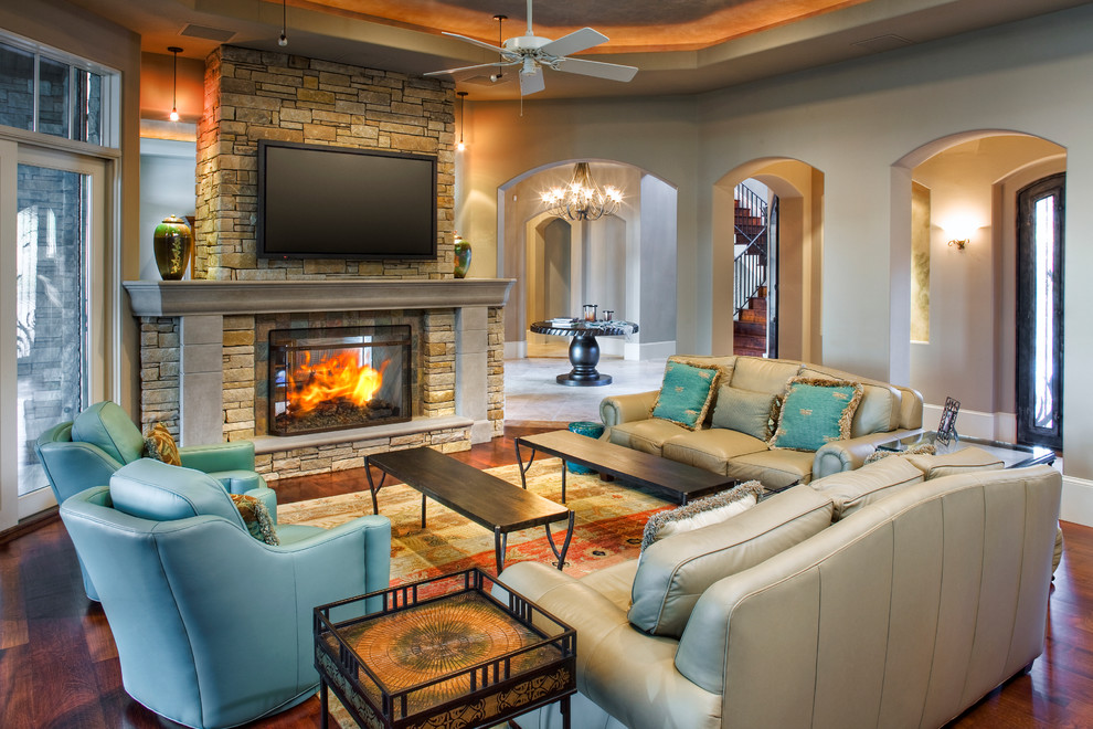 Photo of a traditional living room in Austin with a two-sided fireplace and a wall-mounted tv.