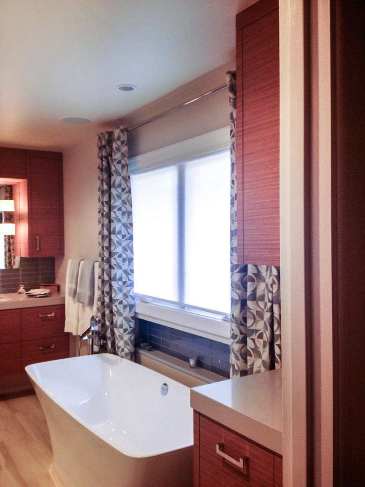 Large transitional master gray tile and porcelain tile light wood floor and beige floor freestanding bathtub photo with flat-panel cabinets, dark wood cabinets, beige walls and quartz countertops