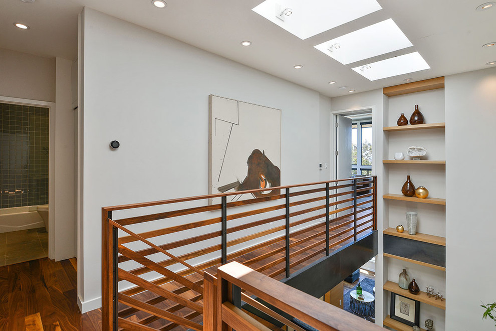 Inspiration for a contemporary hallway in San Francisco with white walls and medium hardwood floors.