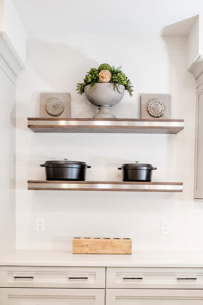 Eat-in kitchen - mid-sized transitional single-wall vinyl floor and brown floor eat-in kitchen idea with quartzite countertops, white backsplash, stainless steel appliances, an island, shaker cabinets, an undermount sink, gray cabinets and porcelain backsplash