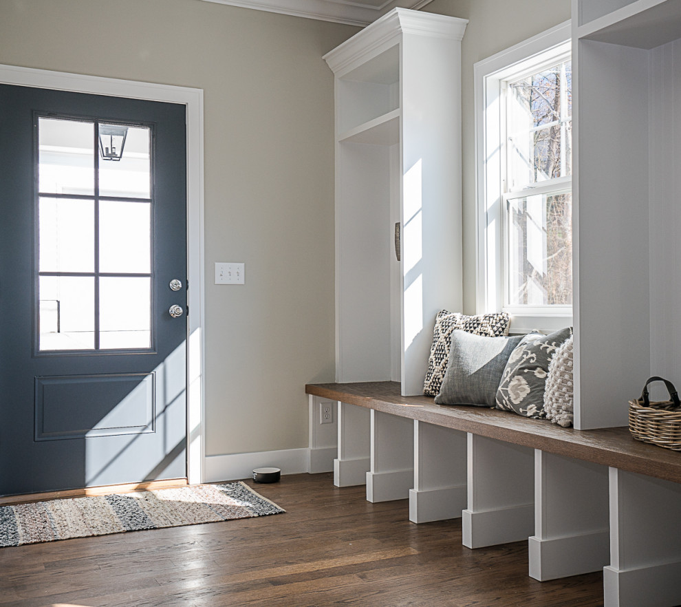 Design ideas for a mid-sized transitional mudroom in St Louis with beige walls, medium hardwood floors, a single front door, a gray front door and brown floor.