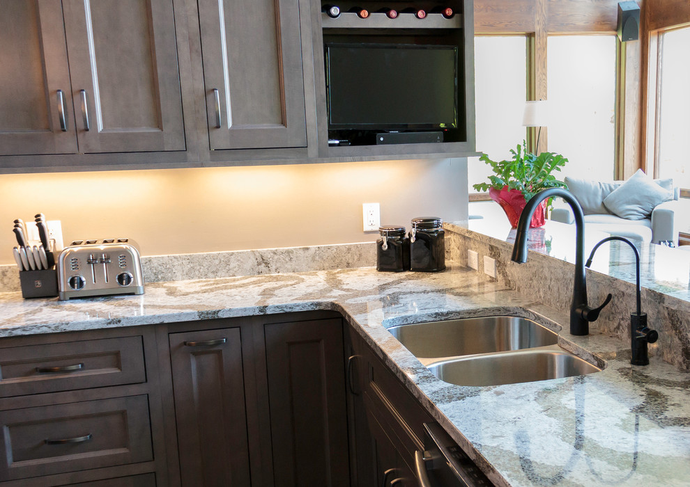Large transitional u-shaped marble floor eat-in kitchen photo with an undermount sink, flat-panel cabinets, quartz countertops, stainless steel appliances and an island