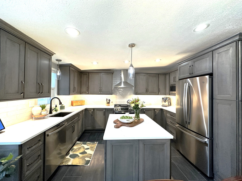 Design ideas for a large classic u-shaped kitchen/diner in Detroit with a submerged sink, shaker cabinets, dark wood cabinets, engineered stone countertops, white splashback, ceramic splashback, stainless steel appliances, porcelain flooring, an island, grey floors and white worktops.