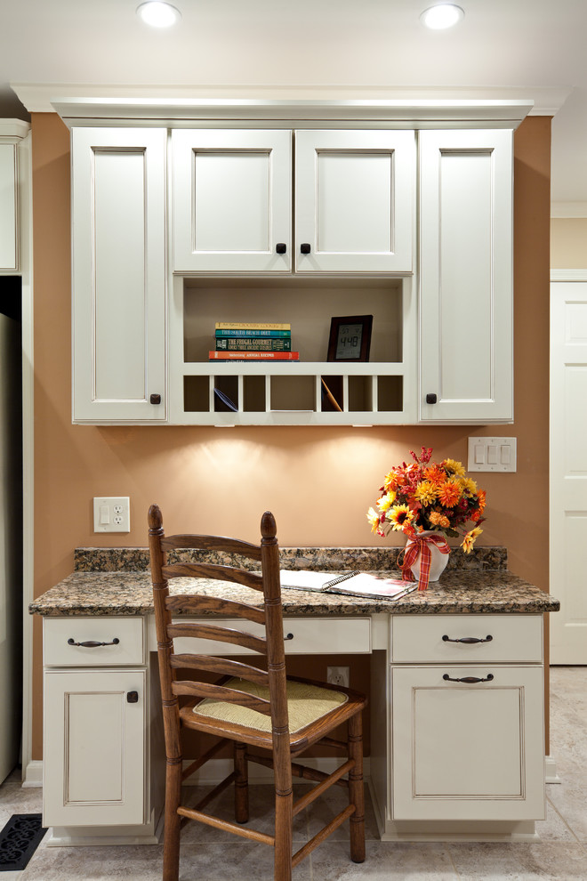 Mid-sized traditional single-wall eat-in kitchen in Atlanta with recessed-panel cabinets, white cabinets, granite benchtops, porcelain floors, beige floor and brown benchtop.