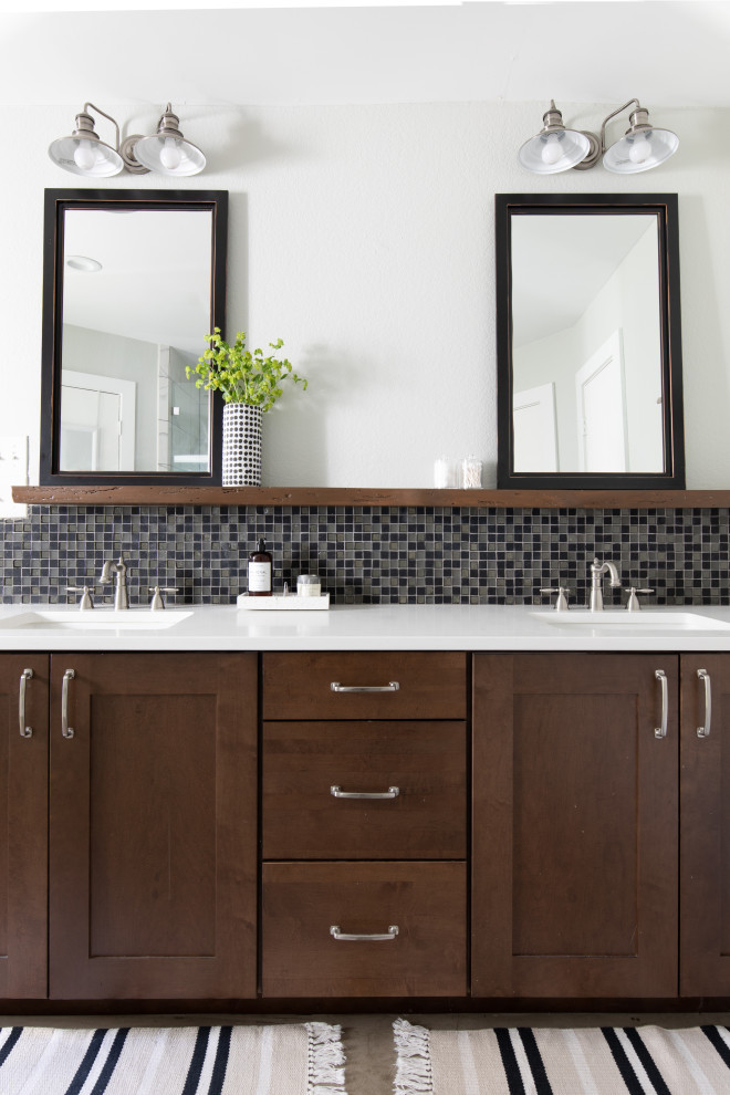 Photo of a mid-sized industrial master bathroom in Austin with shaker cabinets, an alcove shower, white tile, marble, grey walls, concrete floors, an undermount sink, engineered quartz benchtops, grey floor, a hinged shower door, white benchtops, a double vanity, a built-in vanity and dark wood cabinets.