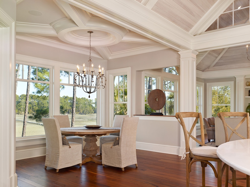 This is an example of a beach style open plan dining in Charleston with beige walls, medium hardwood floors and no fireplace.