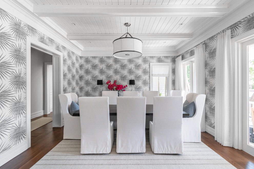 This is an example of a beach style separate dining room in Miami with grey walls, medium hardwood floors, brown floor, exposed beam, timber and wallpaper.