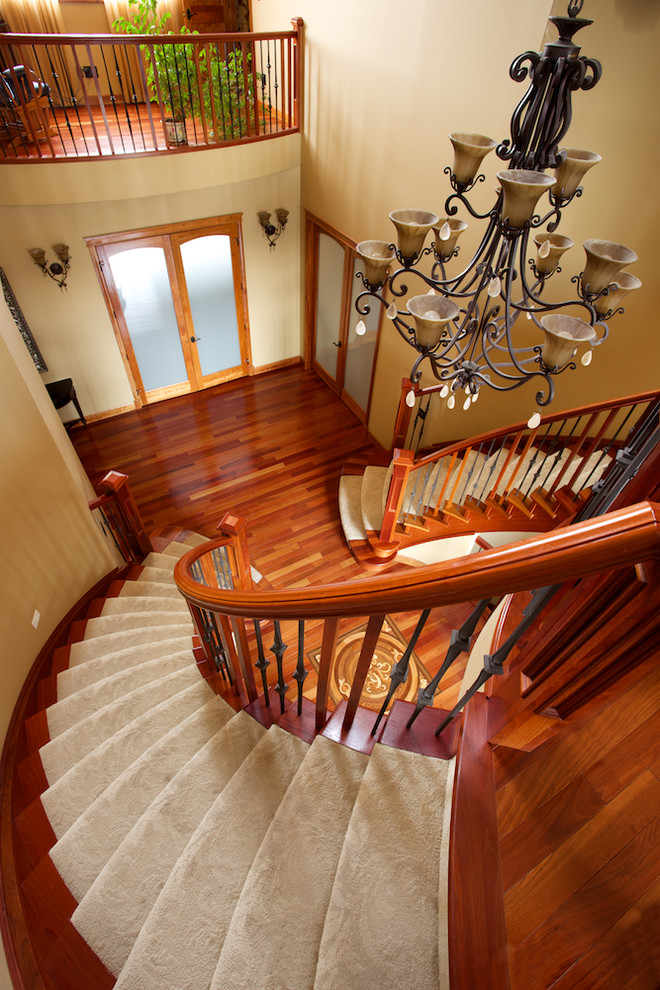 Inspiration for a traditional carpeted curved staircase in Edmonton with carpet risers.