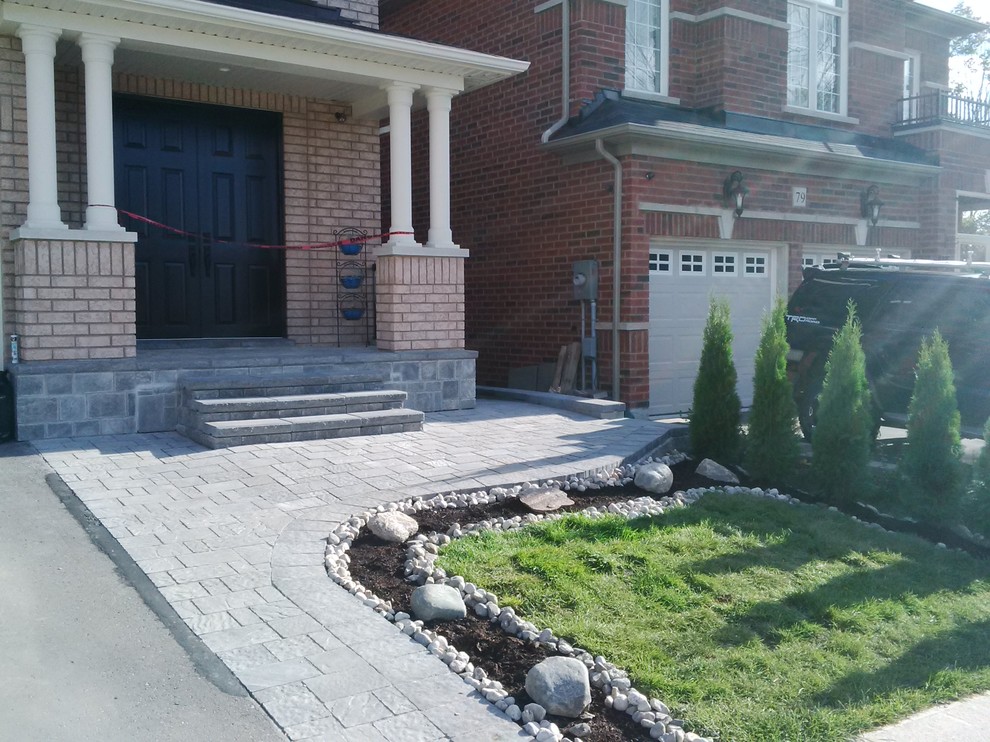 Inspiration for a small partial sun front yard concrete paver landscaping in Toronto.