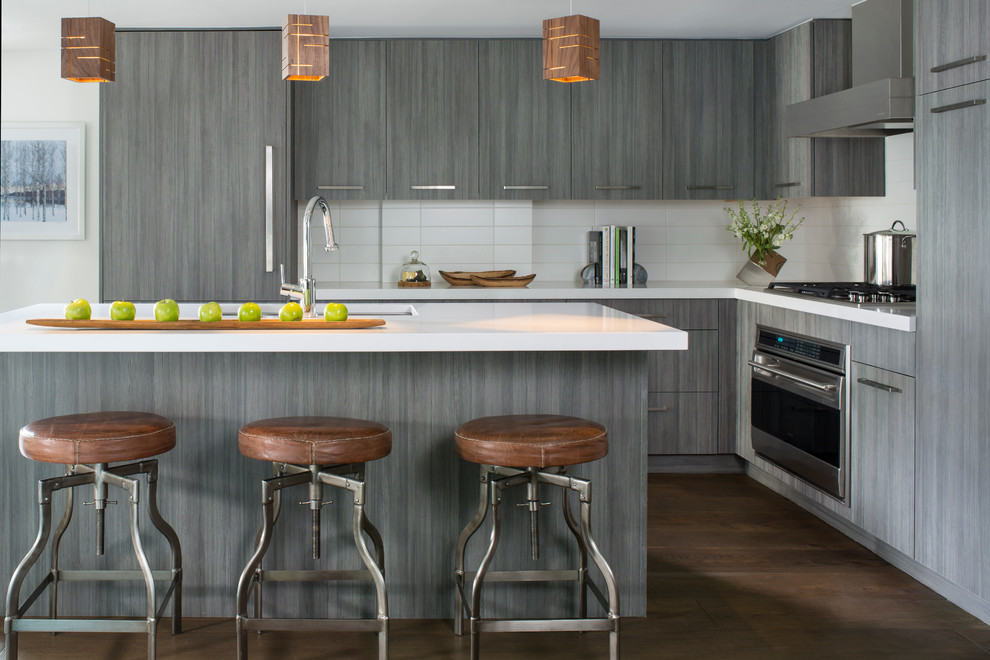 Inspiration for a modern l-shaped dark wood floor kitchen remodel in Denver with flat-panel cabinets, gray cabinets, quartzite countertops, white backsplash and an island