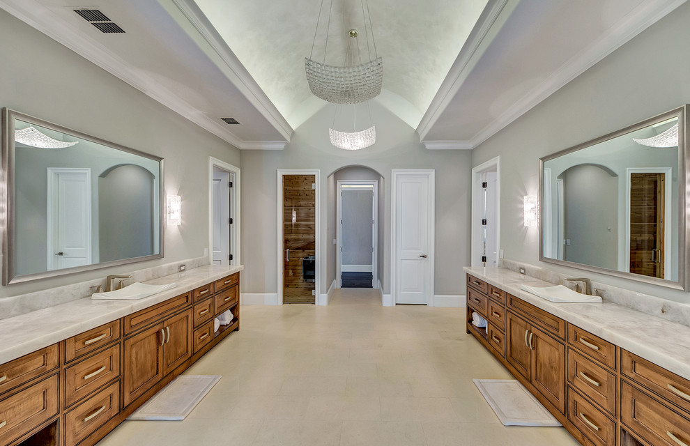 Example of a huge transitional master white tile and stone tile limestone floor and white floor freestanding bathtub design in Orange County with shaker cabinets, dark wood cabinets, a one-piece toilet, gray walls, a drop-in sink and quartzite countertops