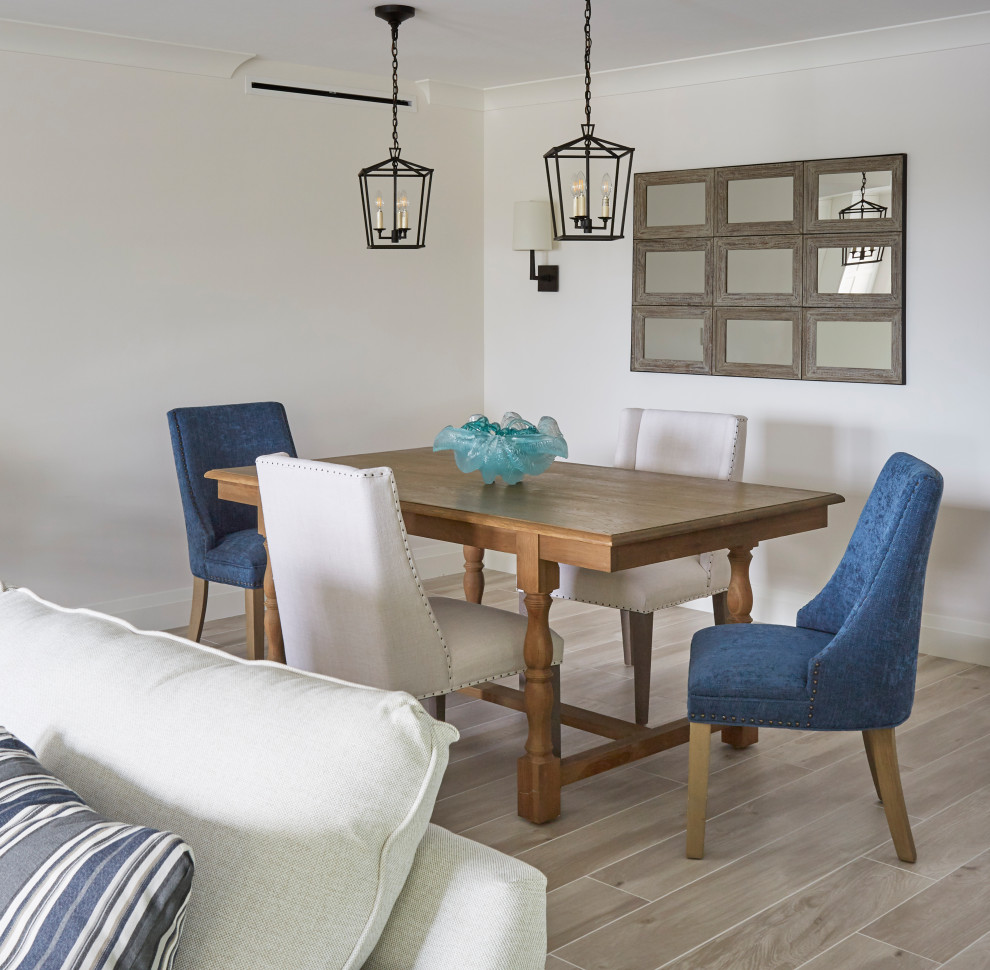 This is an example of a mid-sized beach style open plan dining with grey walls, porcelain floors and grey floor.