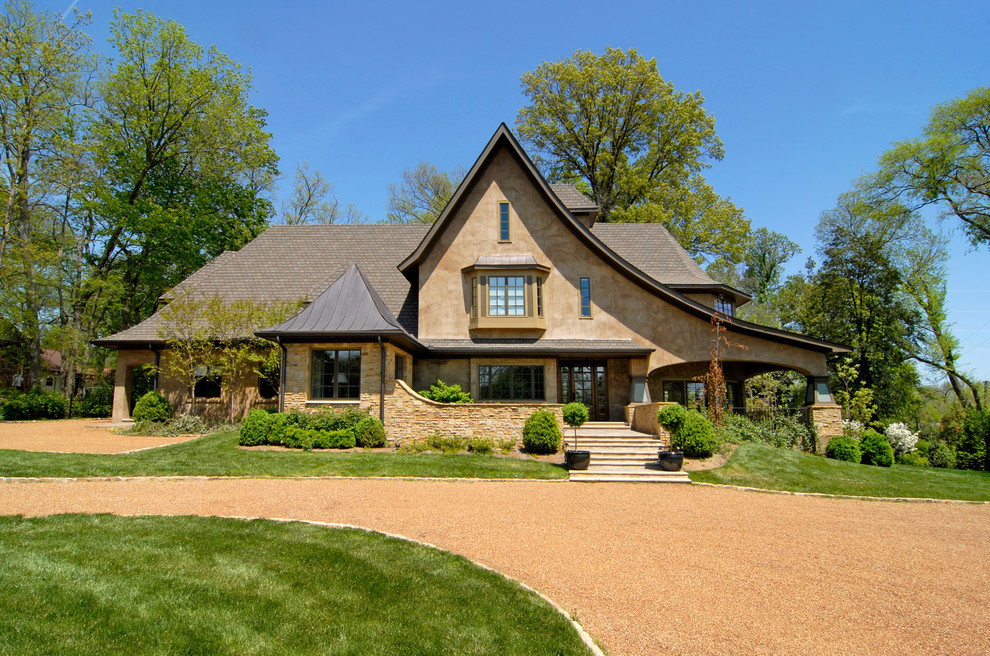 Inspiration for a large traditional three-storey beige exterior in Nashville with stone veneer and a clipped gable roof.