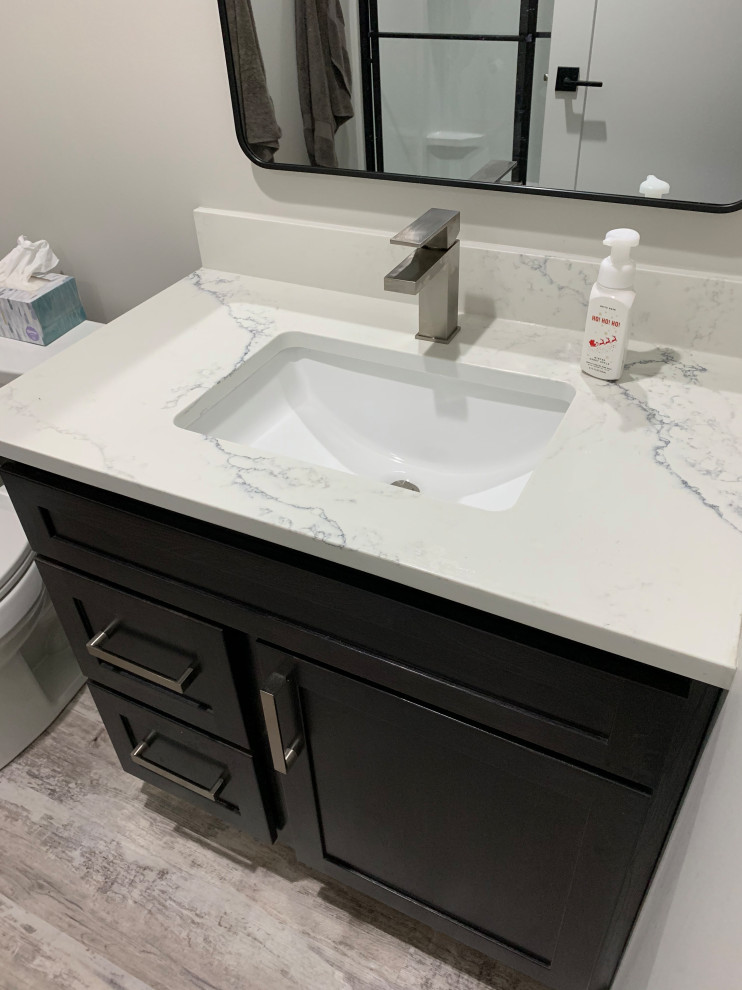 Design ideas for a large transitional kids bathroom in Other with recessed-panel cabinets, grey cabinets, a one-piece toilet, blue walls, vinyl floors, an undermount sink, engineered quartz benchtops, grey floor, white benchtops, a single vanity and a built-in vanity.