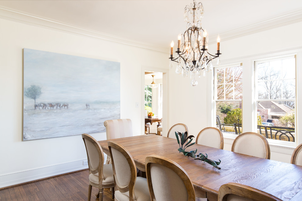 This is an example of a large separate dining room in Birmingham with white walls, medium hardwood floors, no fireplace and brown floor.