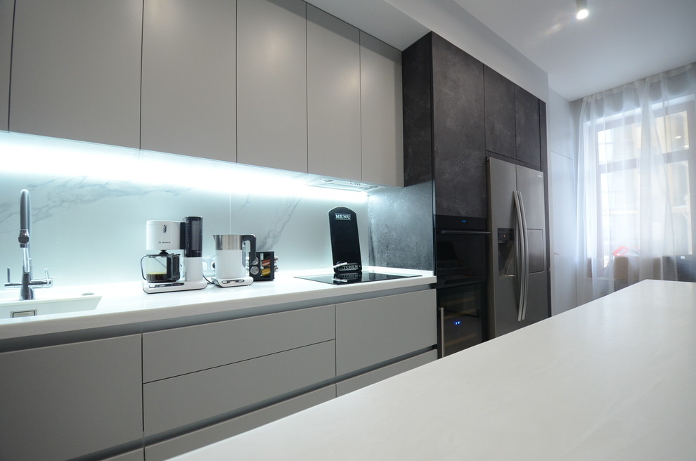 Photo of a large contemporary single-wall eat-in kitchen in Saint Petersburg with an integrated sink, flat-panel cabinets, black cabinets, marble benchtops, white splashback, marble splashback, marble floors, with island, white floor and white benchtop.