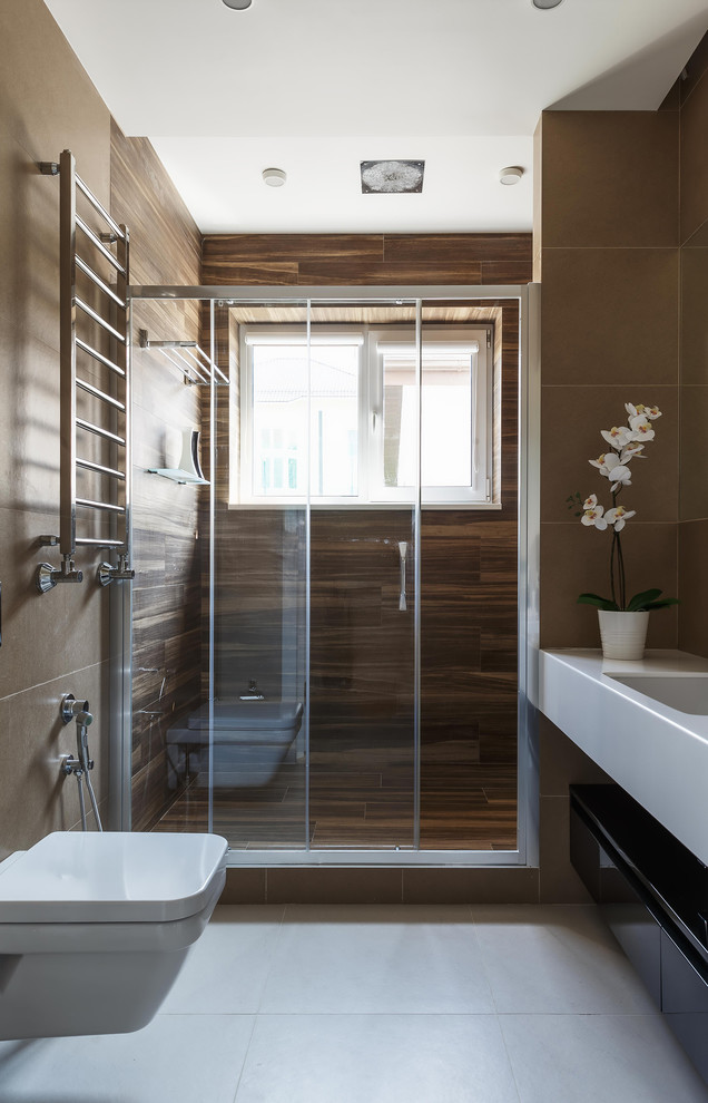 Photo of a small contemporary bathroom in Moscow with black cabinets, beige tile, porcelain tile, porcelain floors, an undermount sink, engineered quartz benchtops, white floor, white benchtops, an alcove shower, a wall-mount toilet and a sliding shower screen.