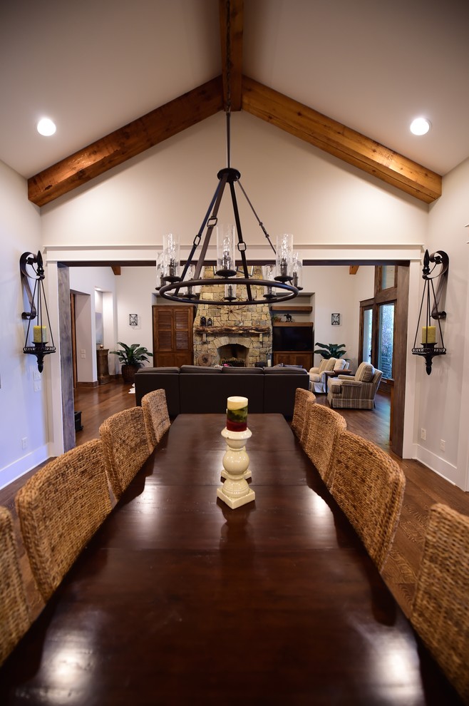 Large mountain style u-shaped medium tone wood floor dining room photo with an undermount sink, shaker cabinets, white cabinets, granite countertops, beige backsplash, stone tile backsplash, stainless steel appliances and an island